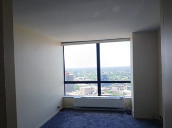 5415 N Sheridan Rd Unit 3615, Chicago, IL 60640 - unfurnished room with a wall of windows, dark colored carpet, and a view of city