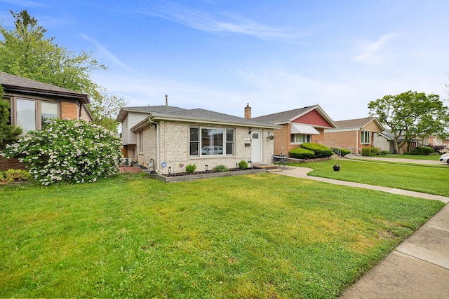 2946 W 102nd St, Evergreen Park, IL 60805 - view of front of home featuring brick siding, a chimney, and a front lawn