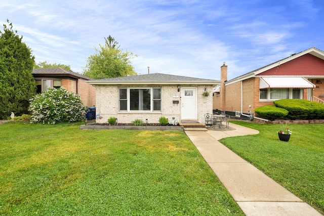 2946 W 102nd St, Evergreen Park, IL 60805 - view of front of home featuring brick siding, a front yard, and a patio