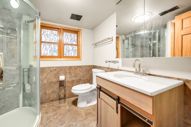 2946 W 102nd St, Evergreen Park, IL 60805 - bathroom featuring vanity, a shower stall, tile walls, tile patterned floors, and wainscoting