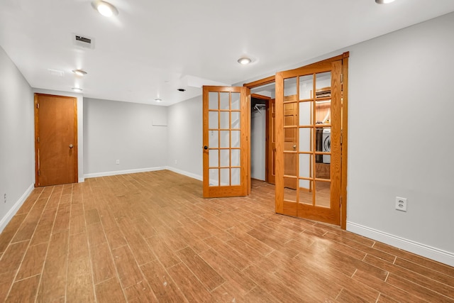 2946 W 102nd St, Evergreen Park, IL 60805 - empty room with french doors, wood finished floors, and washer / dryer