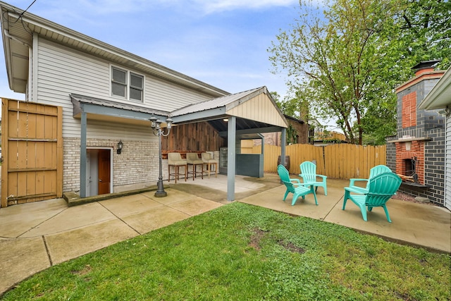 2946 W 102nd St, Evergreen Park, IL 60805 - back of property with a brick fireplace, a patio, and brick siding