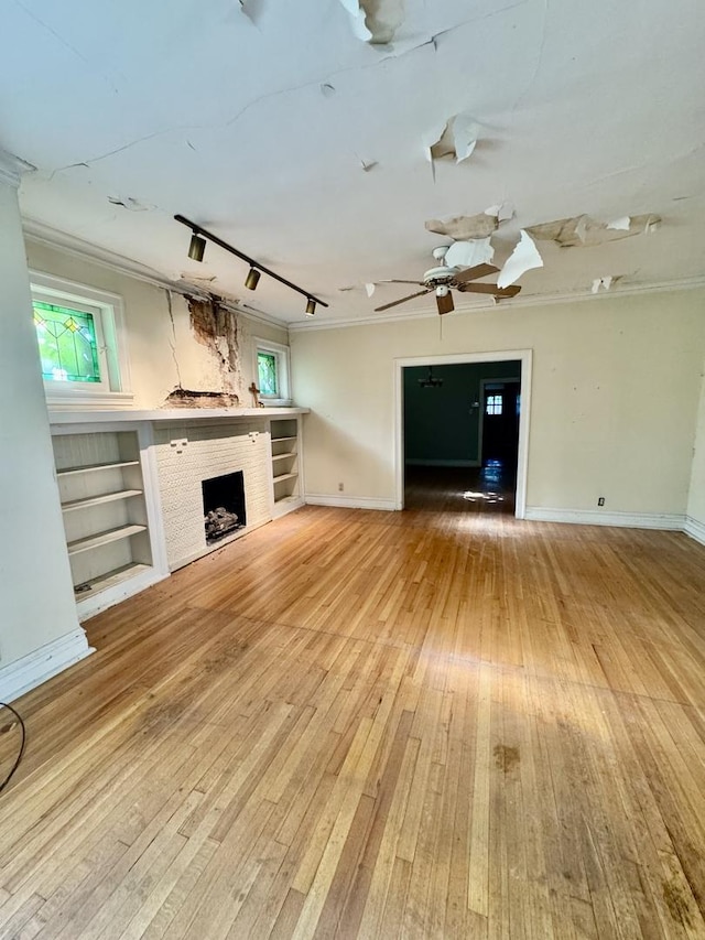 2925 W Eastwood Ave, Chicago, IL 60525 - unfurnished living room featuring light wood-style floors, a fireplace, ornamental molding, and ceiling fan