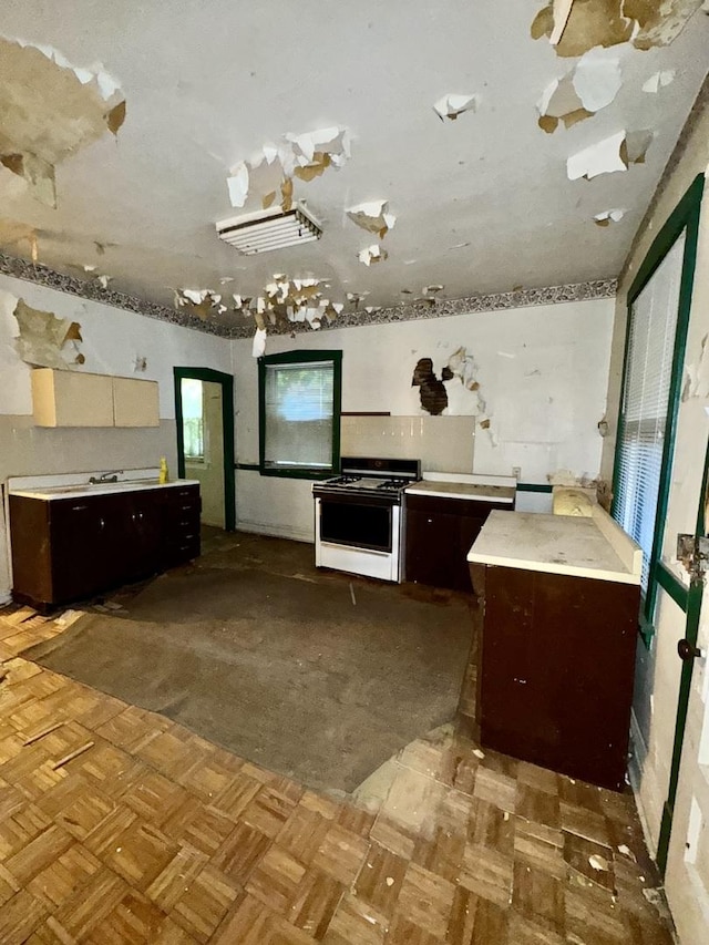 2925 W Eastwood Ave, Chicago, IL 60525 - kitchen with gas range gas stove, dark brown cabinetry, and light countertops