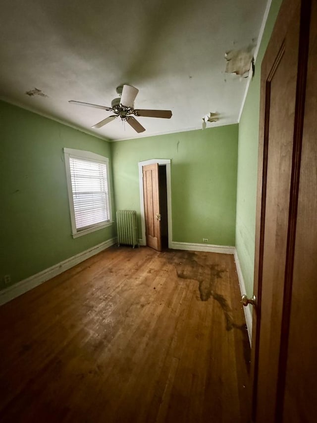 2925 W Eastwood Ave, Chicago, IL 60525 - unfurnished bedroom featuring radiator, wood finished floors, a ceiling fan, and crown molding
