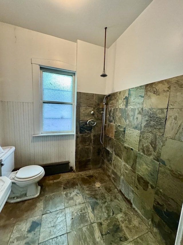 2925 W Eastwood Ave, Chicago, IL 60525 - full bath featuring a tile shower, wainscoting, and stone finish floors