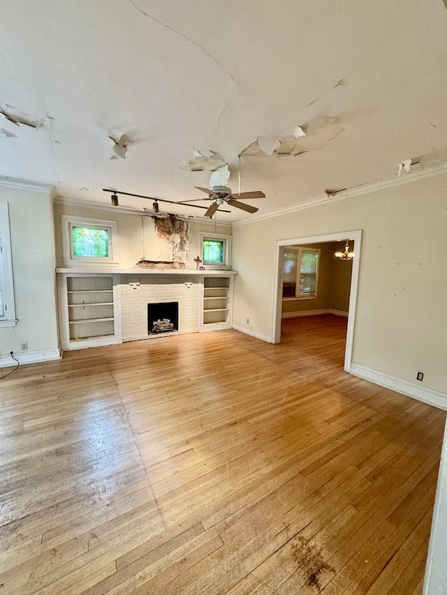2925 W Eastwood Ave, Chicago, IL 60525 - unfurnished living room with ornamental molding, a fireplace, light wood-style flooring, a ceiling fan, and a chandelier