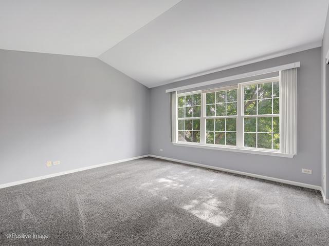 835 Genesee Dr, Naperville, IL 60563 - carpeted spare room with lofted ceiling and baseboards