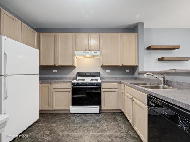 835 Genesee Dr, Naperville, IL 60563 - kitchen with white appliances, under cabinet range hood, open shelves, and light brown cabinets