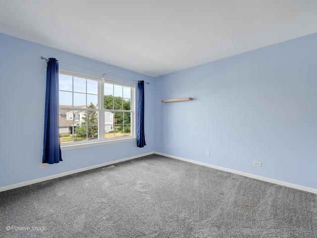 835 Genesee Dr, Naperville, IL 60563 - carpeted spare room featuring baseboards
