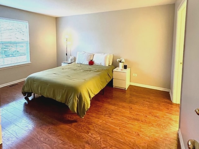 978 N Village Dr, Round Lake Beach, IL 60073 - bedroom featuring wood finished floors and baseboards