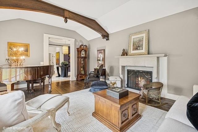 living room featuring vaulted ceiling, wood finished floors, a high end fireplace, and a chandelier
