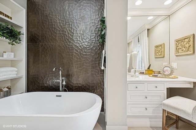 full bathroom with a freestanding tub, vanity, crown molding, and recessed lighting