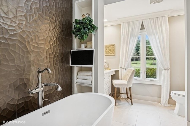 full bathroom featuring a freestanding bath and tile patterned floors