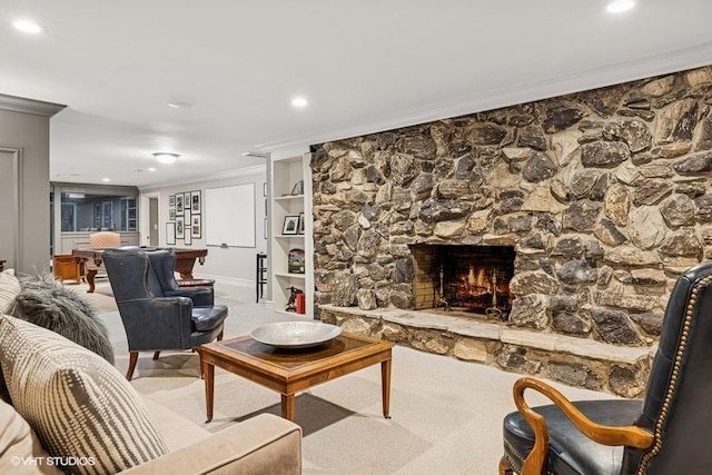 carpeted living room with crown molding, a fireplace, recessed lighting, and built in features