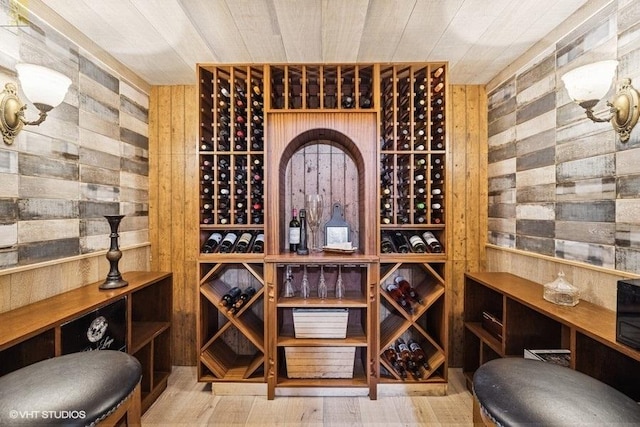 wine cellar featuring wood walls and wood finished floors