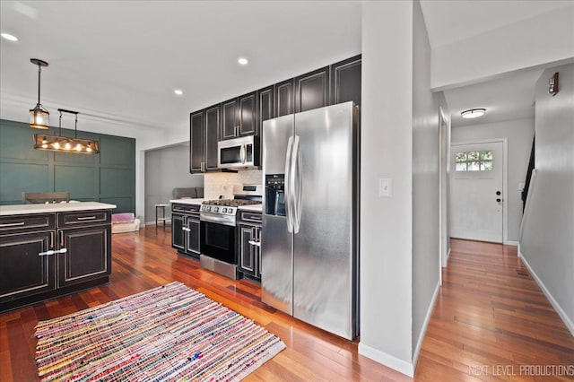 740 Lexington Ave, Saint Charles, IL 60174 - kitchen featuring appliances with stainless steel finishes, hardwood / wood-style floors, light countertops, dark cabinetry, and pendant lighting