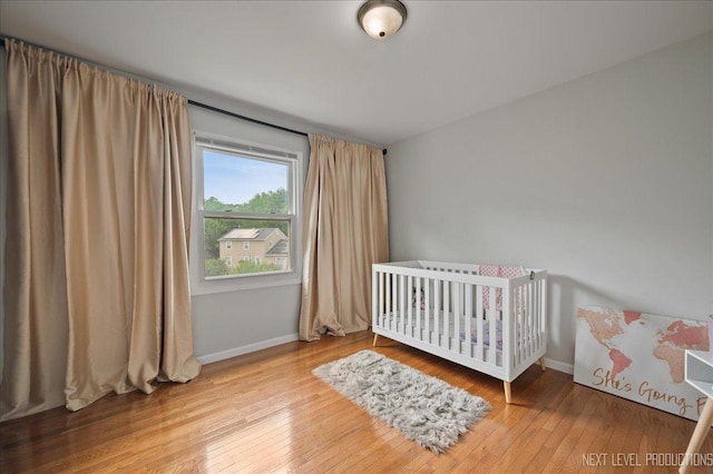 740 Lexington Ave, Saint Charles, IL 60174 - bedroom with hardwood / wood-style flooring and a crib