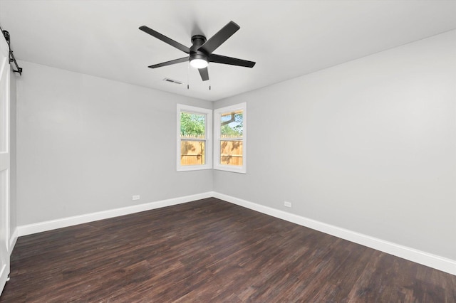 230 Mantua St, Park Forest, IL 60466 - spare room with dark wood-style floors, a ceiling fan, and a barn door