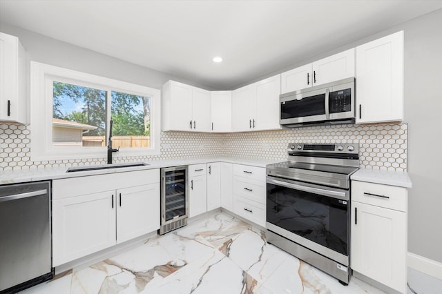 230 Mantua St, Park Forest, IL 60466 - kitchen with appliances with stainless steel finishes, light countertops, wine cooler, white cabinets, and recessed lighting