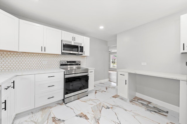230 Mantua St, Park Forest, IL 60466 - kitchen featuring appliances with stainless steel finishes, light marble finish floors, white cabinets, recessed lighting, and decorative backsplash
