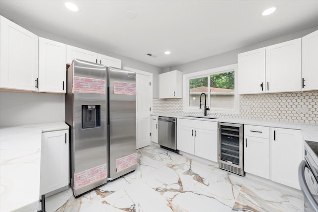 230 Mantua St, Park Forest, IL 60466 - kitchen featuring appliances with stainless steel finishes, beverage cooler, recessed lighting, decorative backsplash, and white cabinets