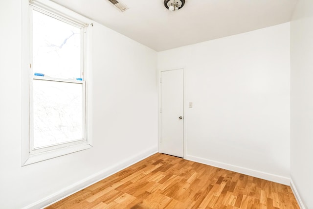 7523 S Kimbark Ave, Chicago, IL 60619 - unfurnished room featuring light wood-type flooring and plenty of natural light