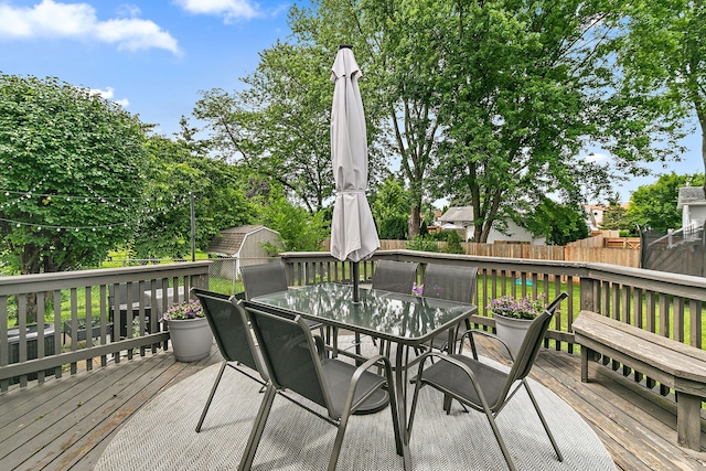 588 Arthur Dr, Cary, IL 60013 - wooden terrace with outdoor dining space, a fenced backyard, and a storage unit