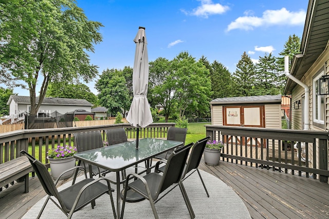 588 Arthur Dr, Cary, IL 60013 - deck with outdoor dining area, a fenced backyard, and an outdoor structure