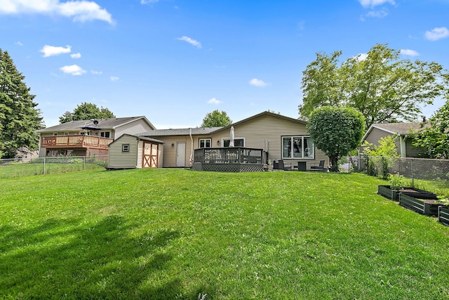 588 Arthur Dr, Cary, IL 60013 - back of house with a wooden deck, a storage shed, a fenced backyard, and a garden
