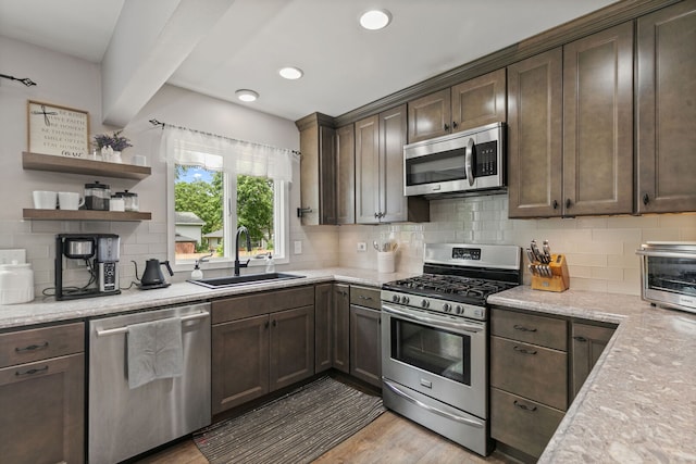 588 Arthur Dr, Cary, IL 60013 - kitchen featuring stainless steel appliances, tasteful backsplash, dark brown cabinets, light wood-style flooring, and open shelves