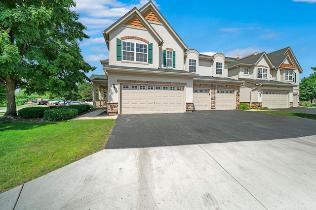 415 Bay Tree Cir, Vernon Hills, IL 60061 - view of front of property with a garage, driveway, stone siding, a front yard, and stucco siding