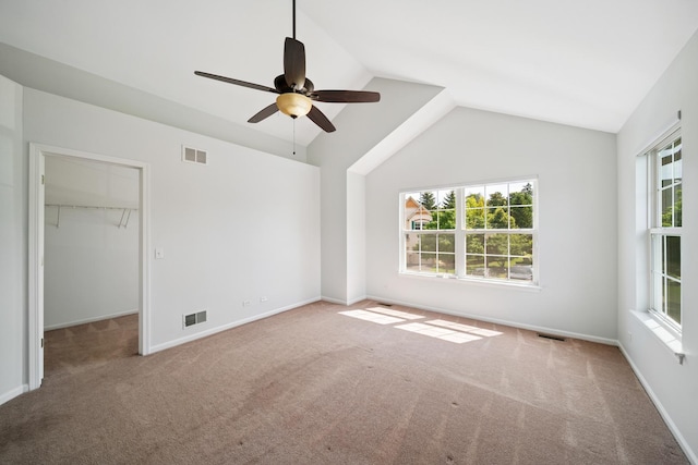 415 Bay Tree Cir, Vernon Hills, IL 60061 - unfurnished bedroom featuring multiple windows, carpet floors, vaulted ceiling, and a walk in closet