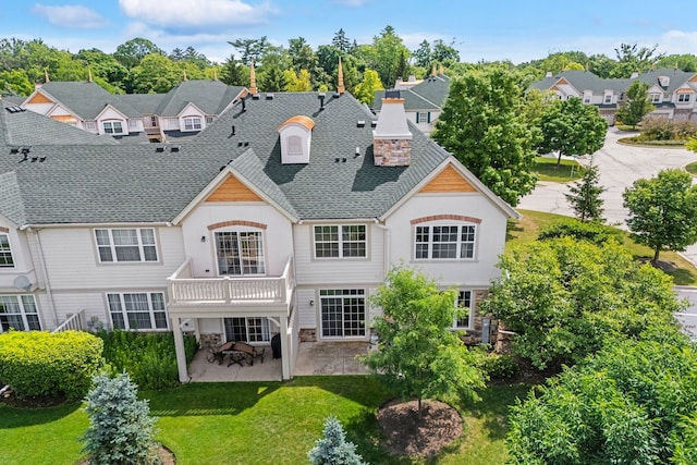 415 Bay Tree Cir, Vernon Hills, IL 60061 - back of property with stone siding, a patio area, a yard, a shingled roof, and a chimney