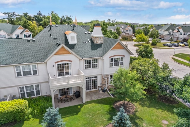 415 Bay Tree Cir, Vernon Hills, IL 60061 - rear view of house featuring a patio, a residential view, a lawn, roof with shingles, and a chimney