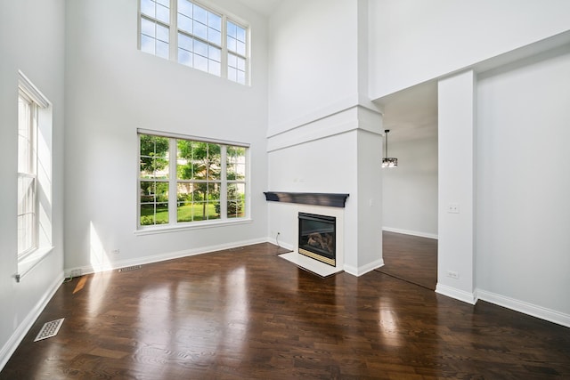 415 Bay Tree Cir, Vernon Hills, IL 60061 - unfurnished living room featuring a high ceiling, a fireplace with flush hearth, and wood finished floors