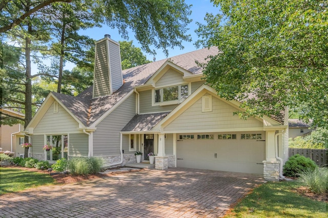 2 Cedar Gate Cir, Sugar Grove, IL 60554 - view of front of home featuring an attached garage, decorative driveway, roof with shingles, a chimney, and stone siding