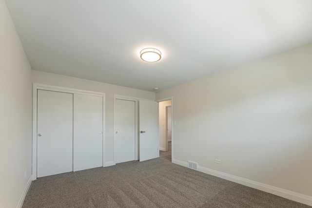 15709 Maryland Ave, Dolton, IL 60419 - unfurnished bedroom with multiple closets and carpet
