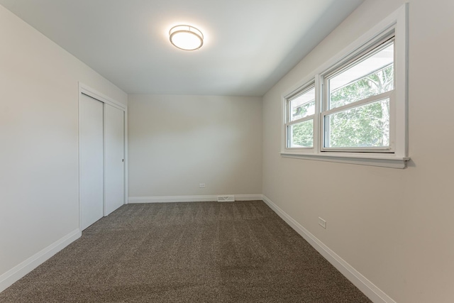 15709 Maryland Ave, Dolton, IL 60419 - unfurnished bedroom with dark carpet and a closet