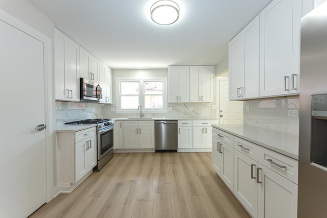 15709 Maryland Ave, Dolton, IL 60419 - kitchen featuring stainless steel appliances, light wood-type flooring, light countertops, and tasteful backsplash