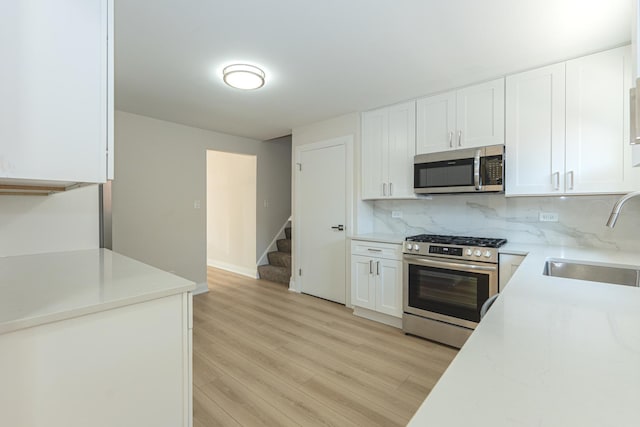 15709 Maryland Ave, Dolton, IL 60419 - kitchen featuring stainless steel appliances, light countertops, backsplash, and white cabinets