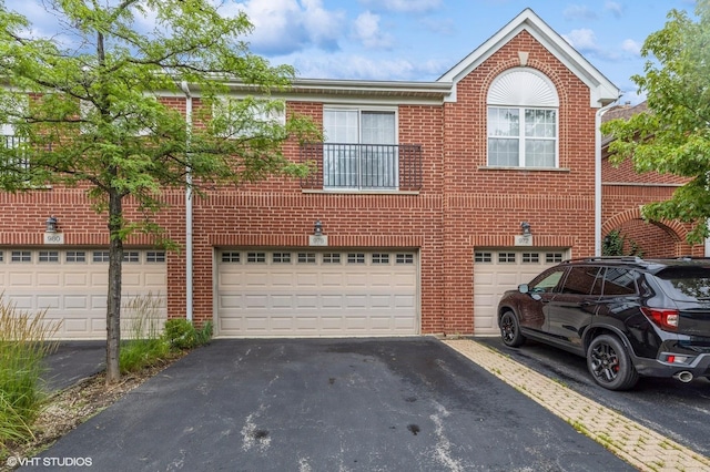 976 Enfield Dr, Northbrook, IL 60062 - view of front of house featuring an attached garage, brick siding, and driveway