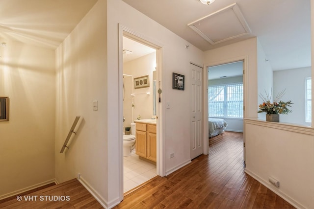 976 Enfield Dr, Northbrook, IL 60062 - corridor featuring light wood finished floors, an upstairs landing, and attic access