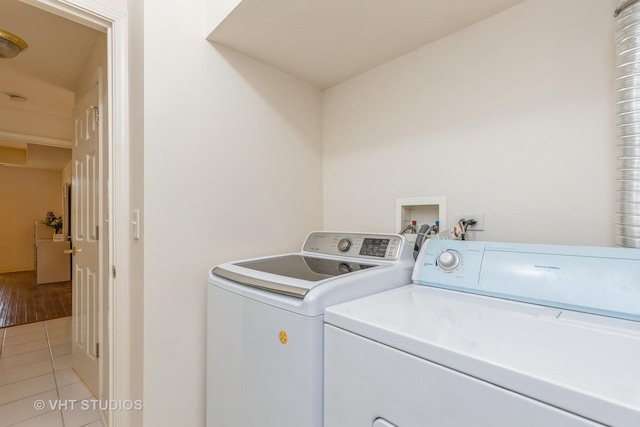 976 Enfield Dr, Northbrook, IL 60062 - washroom with separate washer and dryer and light tile patterned floors