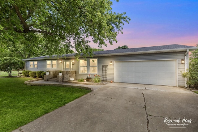 601 E Washington St, Ashkum, IL 60911 - single story home with concrete driveway, a front lawn, and an attached garage