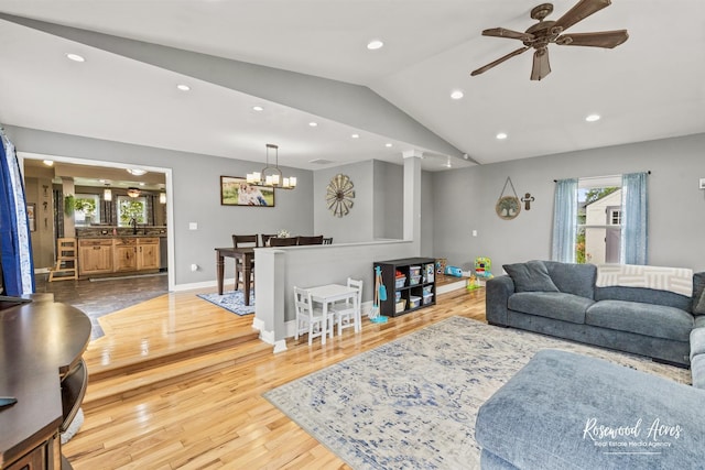 601 E Washington St, Ashkum, IL 60911 - living area featuring lofted ceiling, a ceiling fan, wood finished floors, recessed lighting, and a chandelier