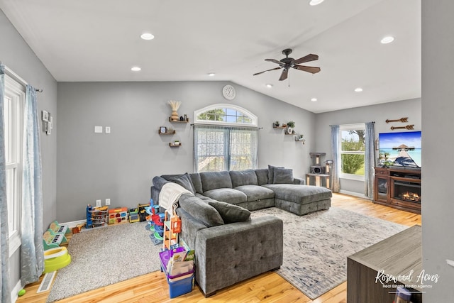 601 E Washington St, Ashkum, IL 60911 - living area with ceiling fan, light wood-style floors, lofted ceiling, healthy amount of natural light, and a lit fireplace