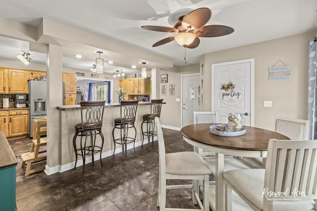 601 E Washington St, Ashkum, IL 60911 - dining area featuring a ceiling fan and baseboards