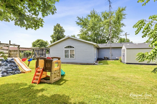 601 E Washington St, Ashkum, IL 60911 - rear view of house with a playground, a storage shed, and a yard