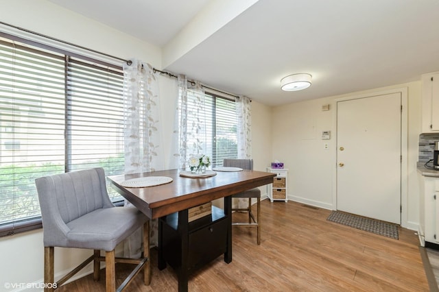6265 Gold Cir Unit 6265, Hanover Park, IL 60133 - dining room with light wood-style flooring and baseboards